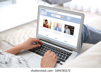 Young woman visiting online dating site via laptop indoors, closeup