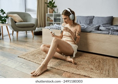 A young woman with vitiligo and a tattoo relaxes in her cozy bedroom, listening to music and enjoying a cup of coffee. - Powered by Shutterstock