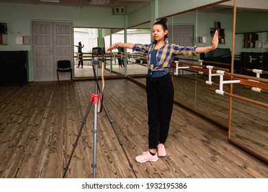 Young Woman Vlogger Recording On Camera A Dance Lesson In A Choreography Hall With Mirrors.