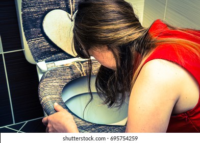 Young woman vomiting in the bathroom - morning sickness during pregnancy - retro style