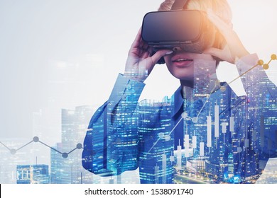 Young woman in VR glasses using it in night city with double exposure of digital charts. Concept of hi tech and future of trading. Toned image