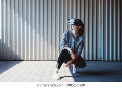 young woman with vr goggles outdoors posing, virtual reality experience
