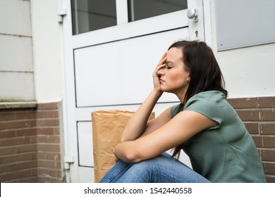 Young Woman Waiting In Front Of Closed Door