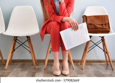 Young woman waiting for interview indoors