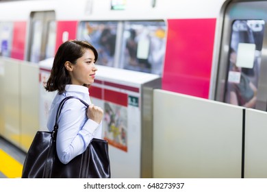 Young Woman Waiting The Subway On Platform.