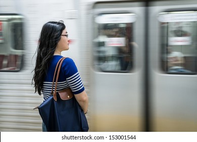 Young Woman Waiting At Subway Station