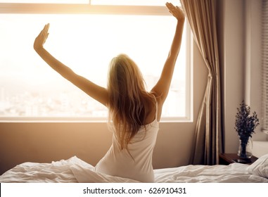 Young Woman Wake Up In Bedroom.