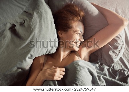 Young woman waking up in the morning in her bed in the bedroom Foto stock © 