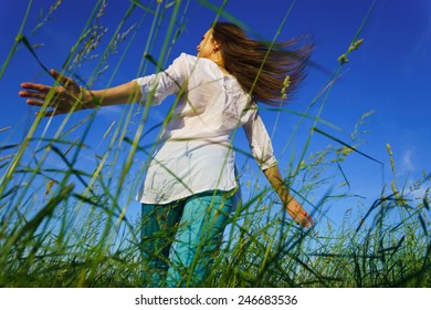 Young Woman Walk On Green Field