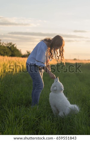 Similar – Image, Stock Photo Blond woman walking her dogs at sunset