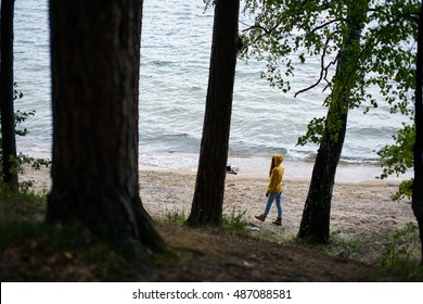 Young Woman Walking Along The Shore