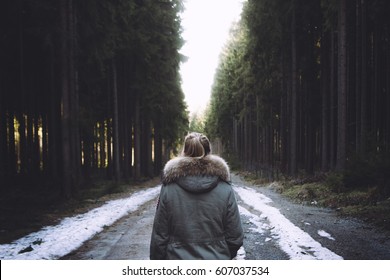 Young Woman Walking Away On A Forest Path.