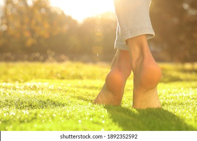 Young Woman Walking Barefoot On Fresh Green Grass, Closeup