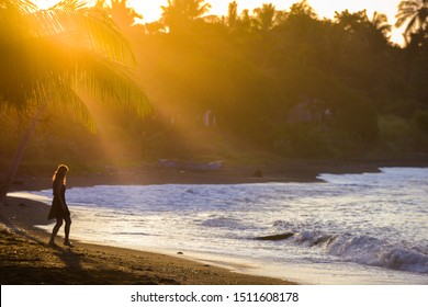 Young Woman walking down the beach at sunset, east side of Bali Indonesia - Shutterstock ID 1511608178