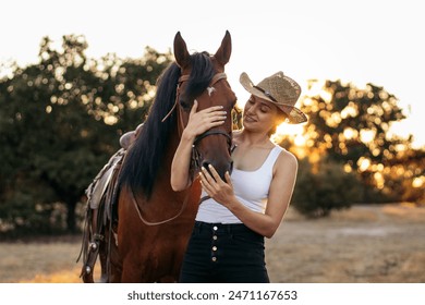 young woman walking with her horse in the countryside as the sun sets behind her. The image conveys sense of freedom and connection with nature - Powered by Shutterstock