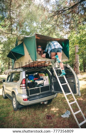 Similar – Image, Stock Photo Women resting and talking lying in tent over car