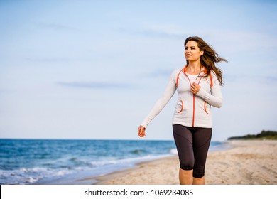 Young woman walking on beach 