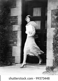 Young Woman Walking Out Door