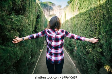 Young woman walking in the park labyrinth in Barcelona - Shutterstock ID 699640687