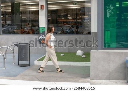 Similar – Image, Stock Photo Young woman walking past yellow building. Motion blur image. Person moving in the city.