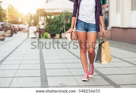 Young woman walking and shopping in the city