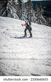 Young woman walking up the slope on her skitouring holiday