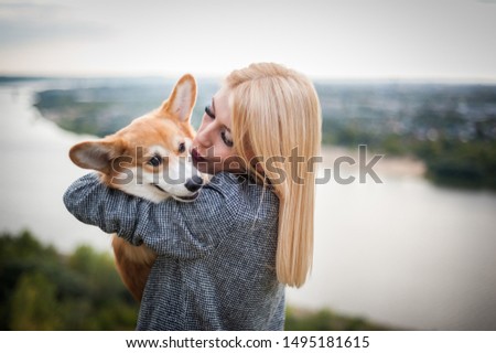 A young woman walks her dog in a summer Park
