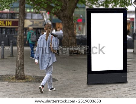 Similar – Image, Stock Photo Young woman walking past yellow building. Motion blur image. Person moving in the city.