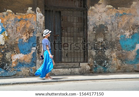 Similar – Image, Stock Photo Young woman walking past yellow building. Motion blur image. Person moving in the city.
