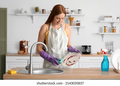 Young woman washing dishes at home - Powered by Shutterstock