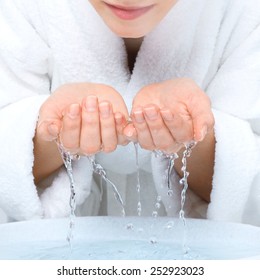 Young Woman Washing Face With Clean Water