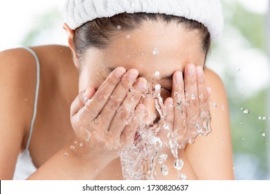 Young Woman Washing Face In Room.