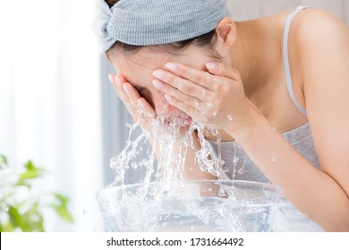 Young Woman Washing Face In Room.