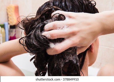 Young Woman Washing Hair With Shampoo In The Shower