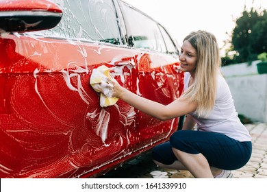 Young Woman Washing Her Car With Sponge. 