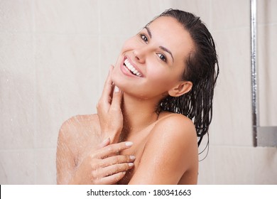 Young Woman Washing Her Head In The Shower By Shampoo