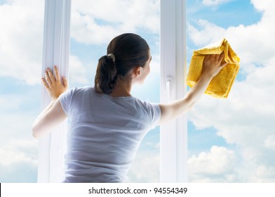 Young Woman Washing Windows