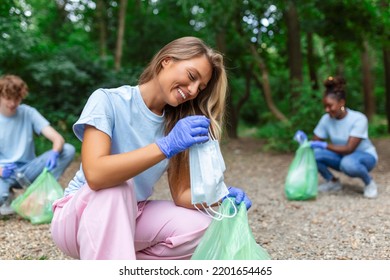 Young Woman Waste Collector Busy Separating Medical Or PPE Waste From Plastic Garbage During The Covid-19 Coronavirus Pandemic