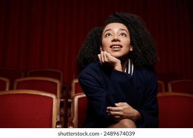 A young woman watches a movie in a theater, captivated by the unfolding story. - Powered by Shutterstock