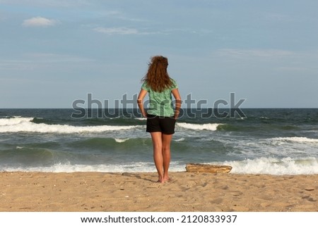 Young woman watching the sea.