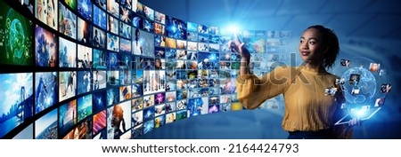Young woman watching stereoscopic images. Digital contents concept. Social networking service. Streaming video. NFT. Non-fungible token. Wide angle visual for banners or  advertisements.