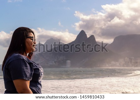Young woman watching the sunset at Pedra do Arpoador, Arpoador Beach, Rio de Janeiro, Brazil