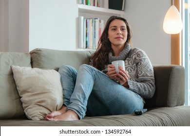 Young Woman Watching Tv Home In Sofa