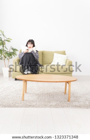 Young woman watching TV at home