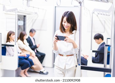 Young Woman Watching A Video On A Train