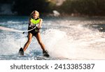 a young woman water skiing on a sea 