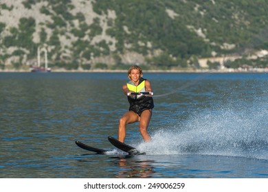 a young woman water skiing on a sea 