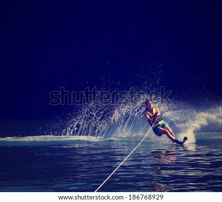  a young woman water skiing on a lake done with a retro vintage instagram filter 