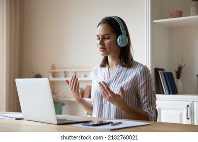 Young Woman Wear Headphones Talk On Video Call App Use Laptop, Online Tutoring, Remote Class In Domestic Kitchen At Quarantine. Virtual Meeting, Study Or Business, Distance Communication, Tech Concept