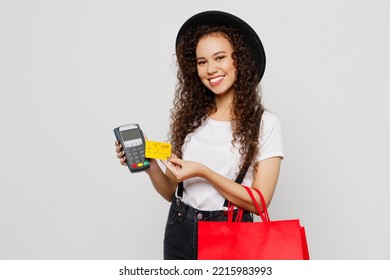 Young woman wear t-shirt hat hold red paper package bags after shopping bank payment terminal to process acquire credit card isolated on plain solid white background. Black Friday sale buy day concept - Shutterstock ID 2215983993